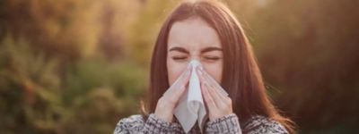 Woman sneezing in autumn because of fall allergies - Williams Comfort Air Heating, Cooling, Plumbing & More