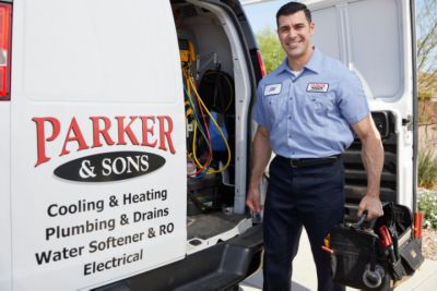 HVAC tech in front of service van