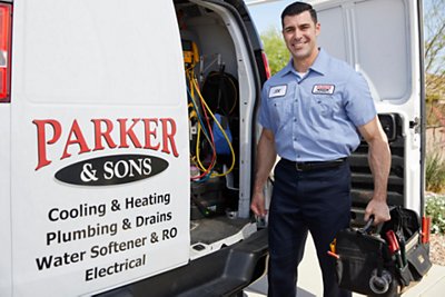HVAC tech in front of service van