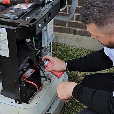 Electrician applying Batter Corrosion Protection - Generator Maintenance