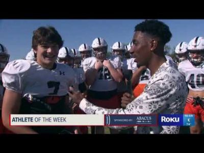 A football player talking to a reporter.