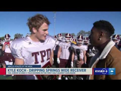 A football player talking to a reporter.