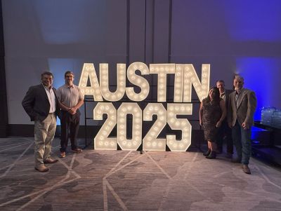 Abacus Leadership Team with Austin 2025 Glowing Sign