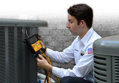 Technician checking an outdoor ac unit