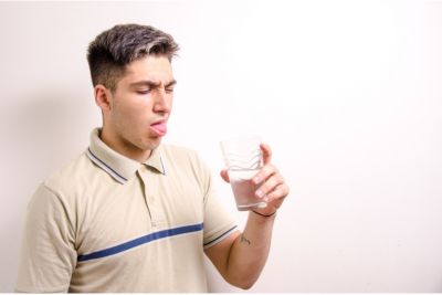 Man making a disgusted face as he drink AZ tap water