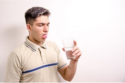 Man making a disgusted face as he drink AZ tap water