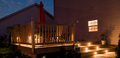 Back deck of house at night with lights on stairs