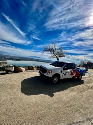 NexGen truch in front of lake with beautiful sky