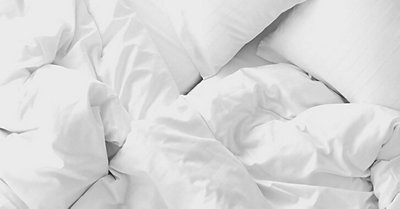 Bed with white pillows and blanket