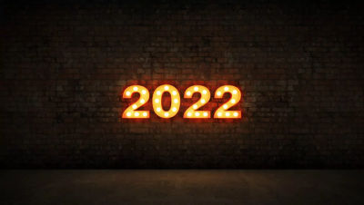 A lighted sign of 2022 on a brick wall