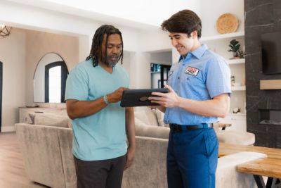 tech showing homeowner a quote on a tablet