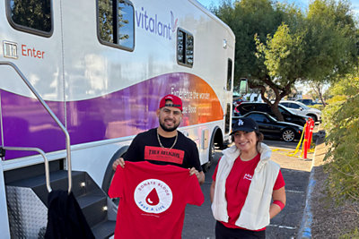 Parker & Sons employees standing outside of blood donation van