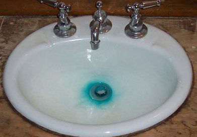 Bluish-green stain in sink by drain