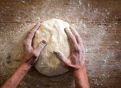 Hand kneading bread dough.