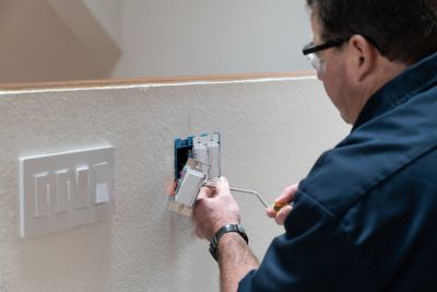 technician working on broken light switch