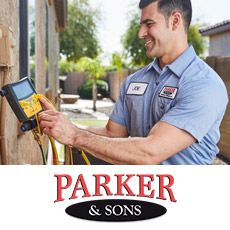 HVAC tech from Parker and Sons insepcting an AC unit