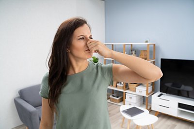 Women smelling burning plastic in her home