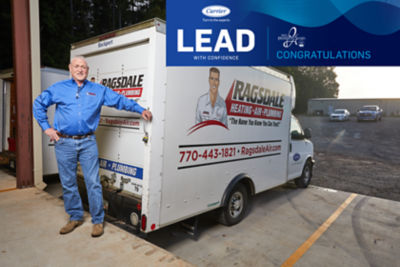 Art Ragsdale poses next to Ragsdale truck with Carrier logo on the right side.