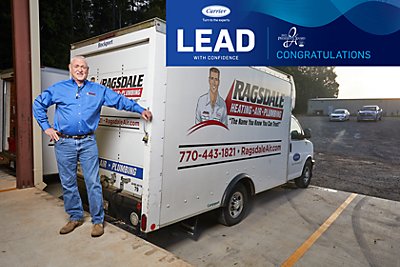 Art Ragsdale poses next to Ragsdale truck with Carrier logo on the right side.