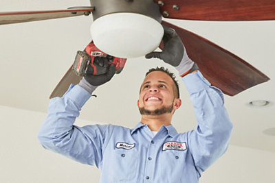 Electrician installing a home ceiling fan 