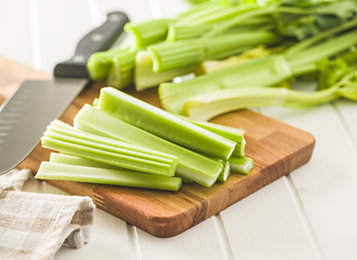 Chopped celery on a cutting board.