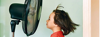 a child looking at a fan