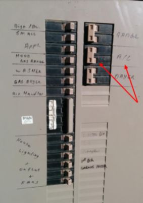 Red arrows pointing at circuit breakers in on position