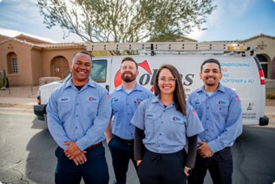 Four smiling techs standing in front of a Collins Comfort van