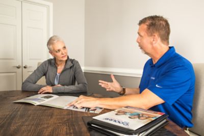 Coolray comfort consultant showing customer options in a Kennesaw home