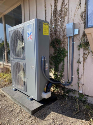 A NexGen AC unit connected to the side of a house.