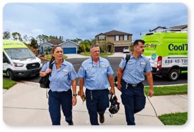 Three smiling Cool Today techs walking up the driveway