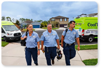 Three smiling Cool Today techs walking up the driveway