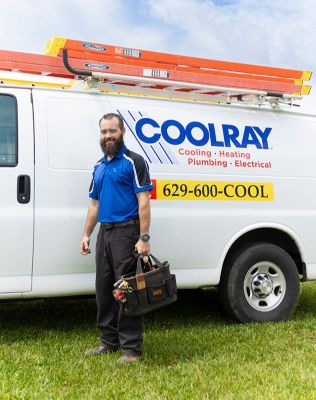 Smiling Coolray tech standing in front of a Coolray van