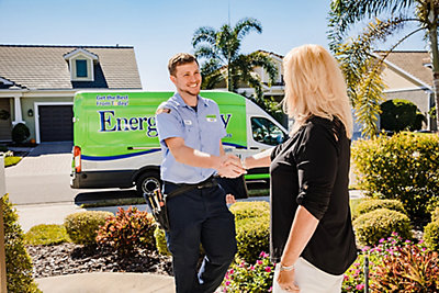 An electrician shaking hands with a Florida homeowner