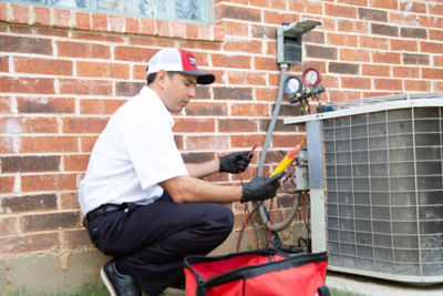 Dallas/Fort Worth technician Diagnosing issues on an outdoor AC condenser unit