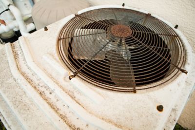 A rusty air conditioner outside.