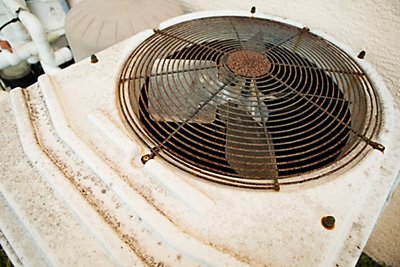 A rusty air conditioner outside.