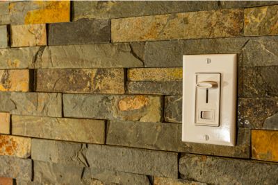 Dimmer switch on a brick looking wall