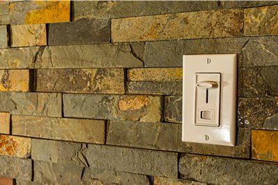 Dimmer switch on a brick looking wall