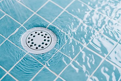 Drain in blue shower
