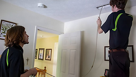Thomas & Galbraith duct cleaning technicians working in a home