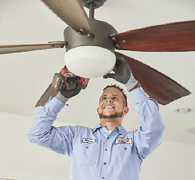 Electrician installing a fan in a Tucson home