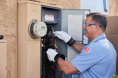 Tech repairing electrical panel