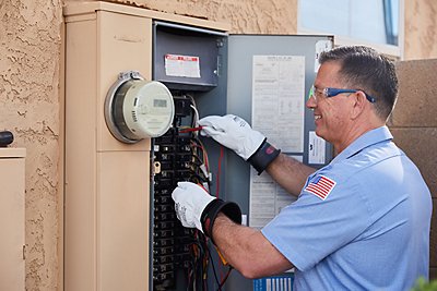 Tech repairing electrical panel