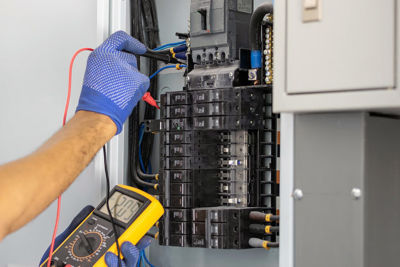 Electrician inspecting panel