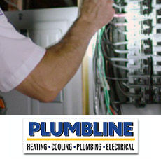 An electrician inspecting an electrical panel at a home in Brighton, CO