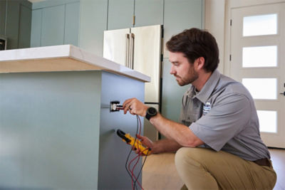 Electrician testing the voltage of an electrical outlet