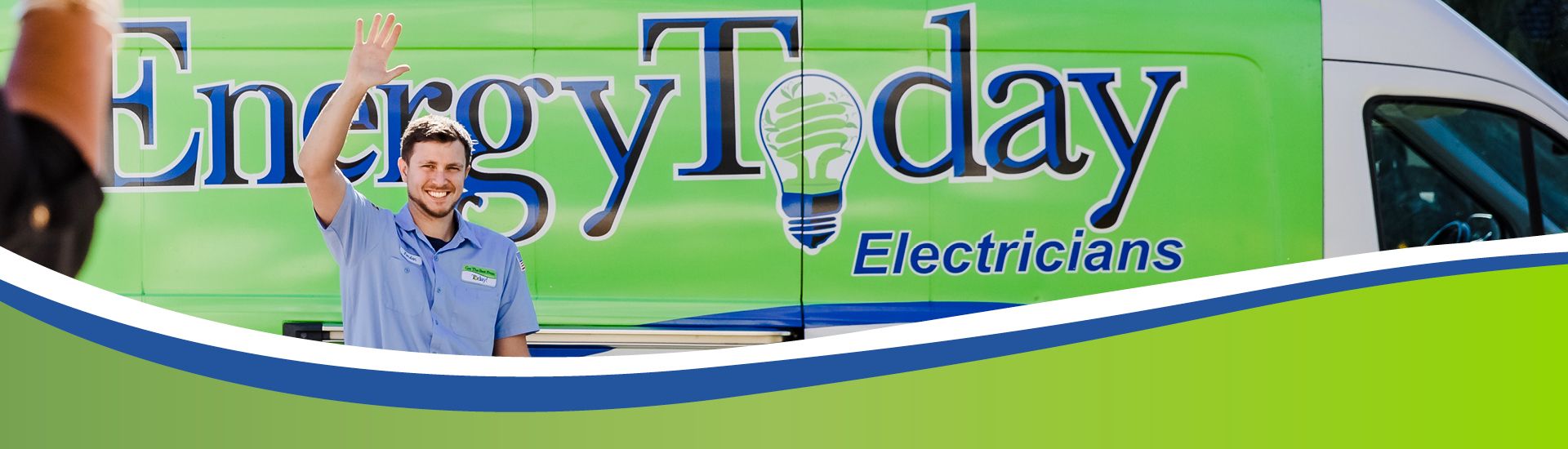 Electrician smiling and waving in front of Energy Today van