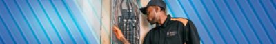 Electrician inspecting electrical panel