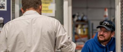 Plumbline employees talking in front of warehouse